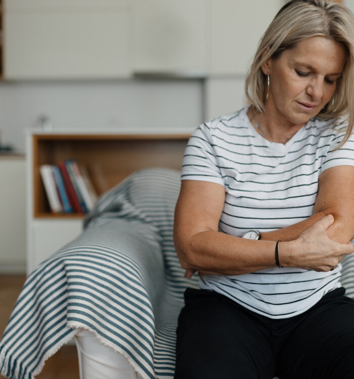 Mid adult woman having elbow pain