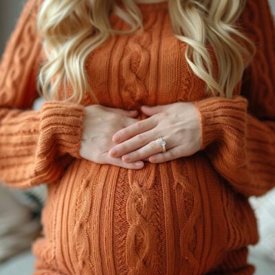 Pregnant woman holding her lower back, red showing back pain